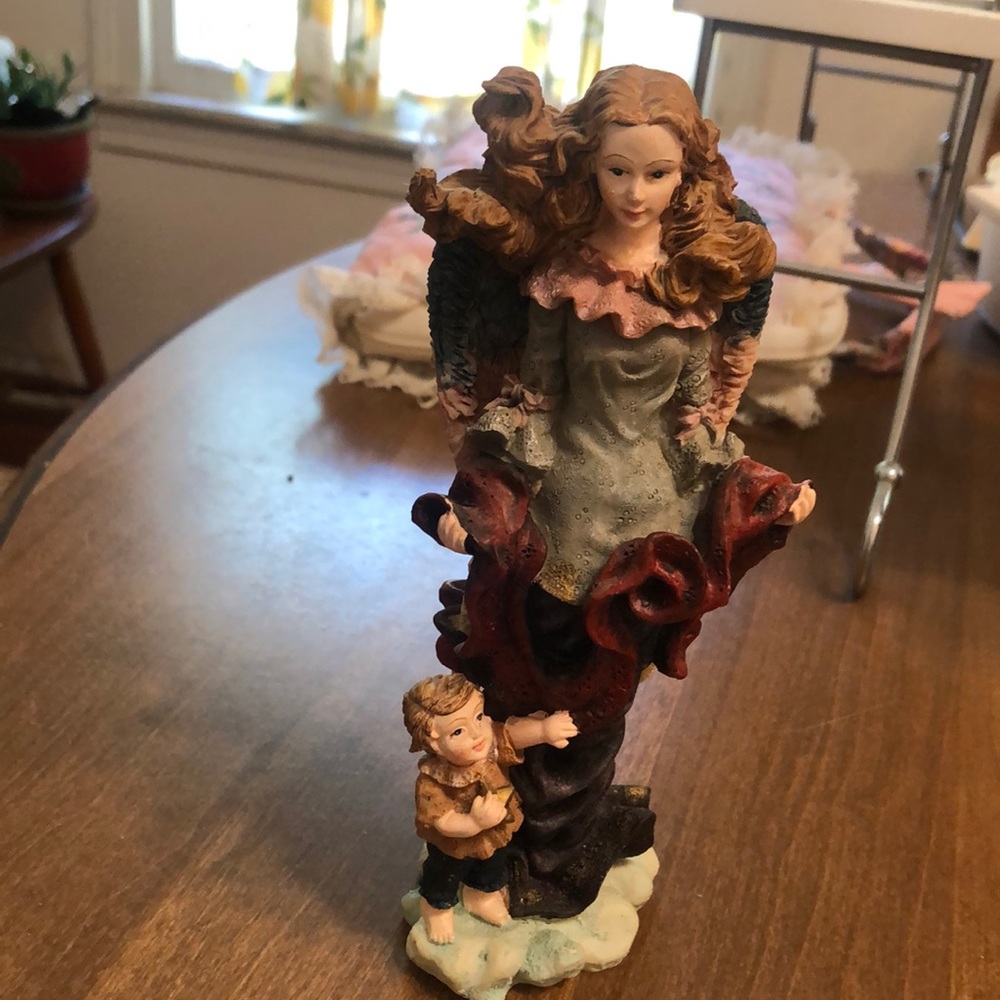 Angel with little boy holding a star. Beautiful coloring. 7 1/2” tall.